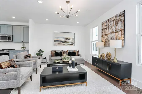 a living room with furniture and kitchen view