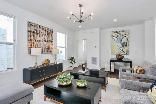 a living room with furniture and a chandelier
