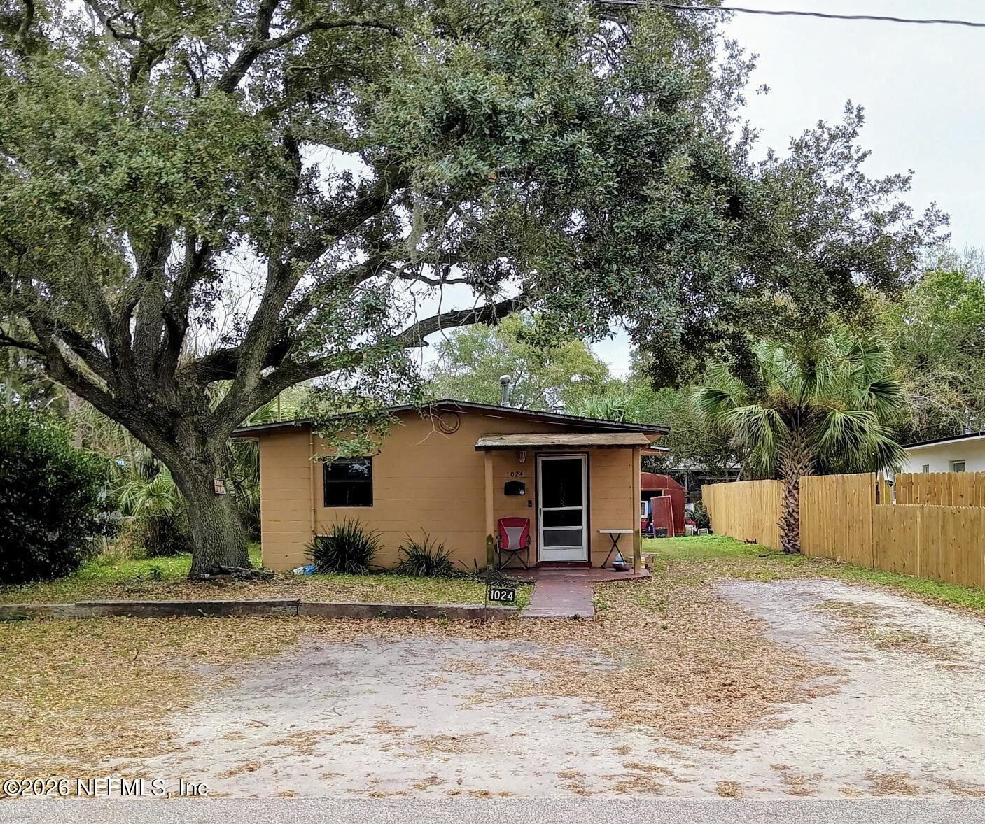 a view of a house with backyard and trees