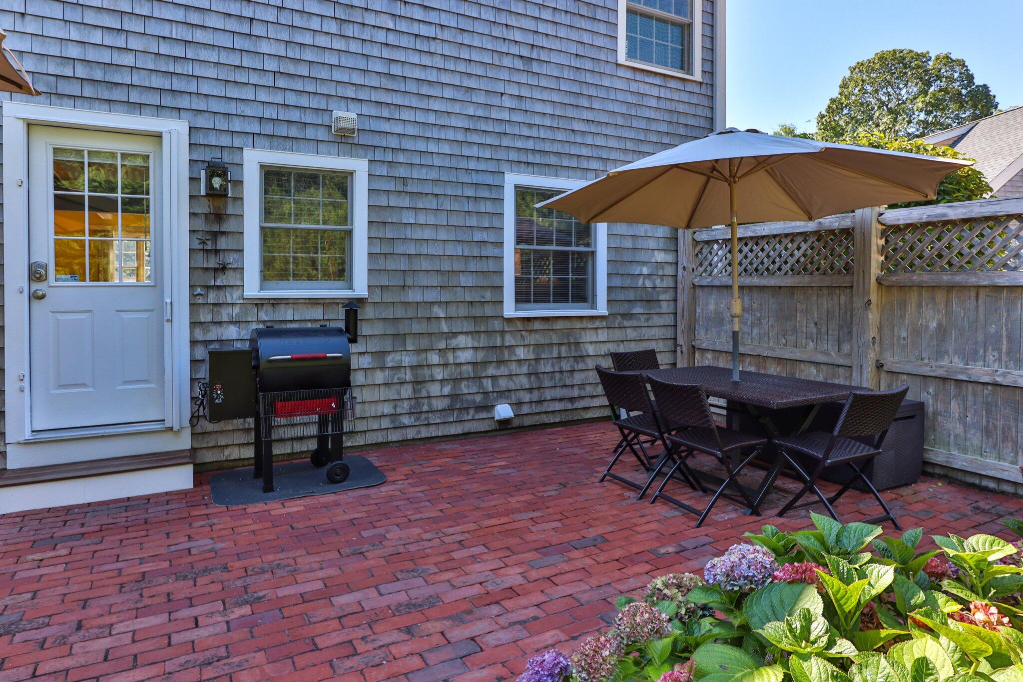 153 Jericho Path, Unit 8U Falmouth, MA 02540 - Photo 26 of 52 a view of a lounge chairs in back yard of the house