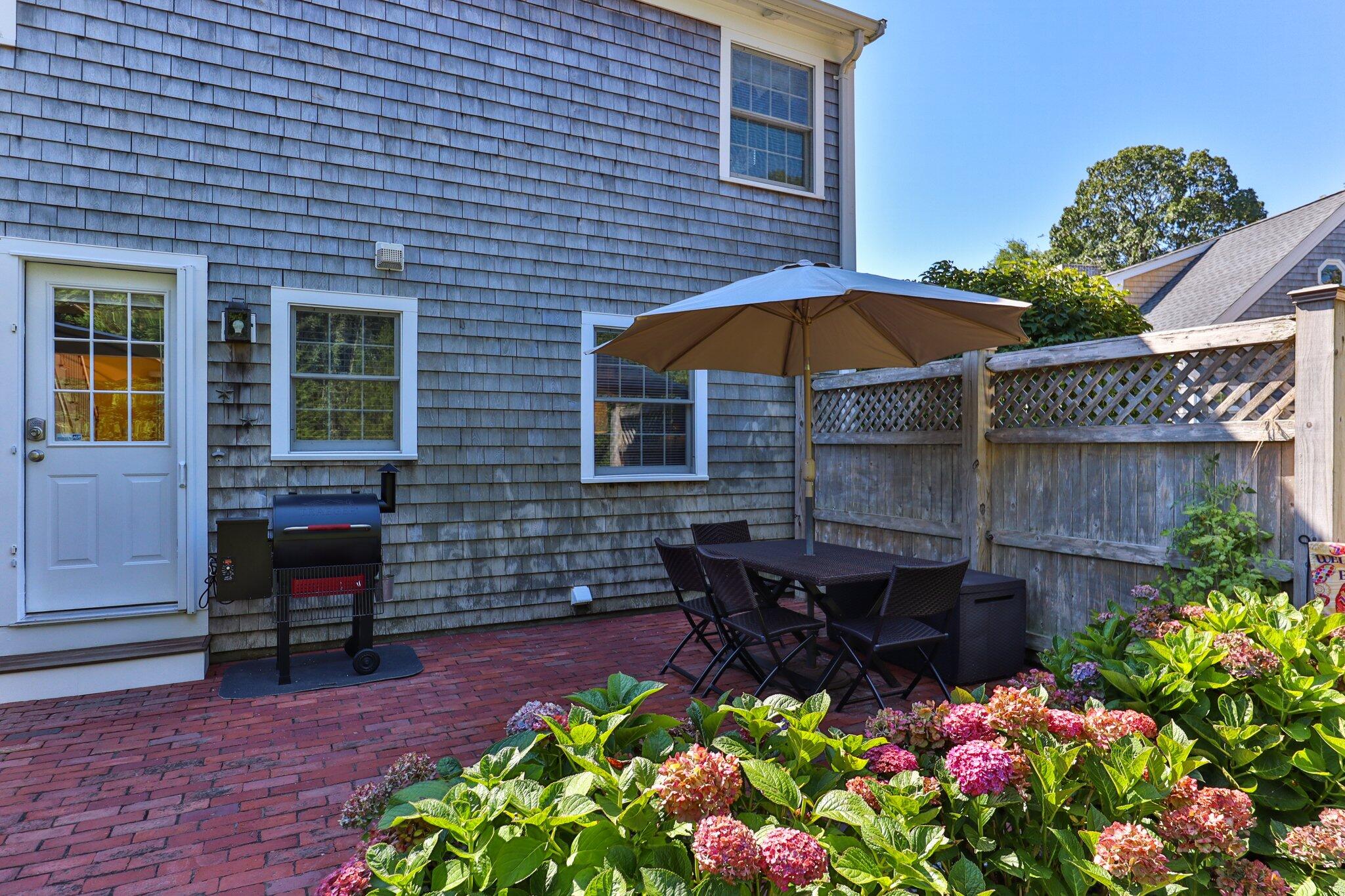 153 Jericho Path, Unit 8U Falmouth, MA 02540 - Photo 28 of 52 a view of a house with a yard and sitting area