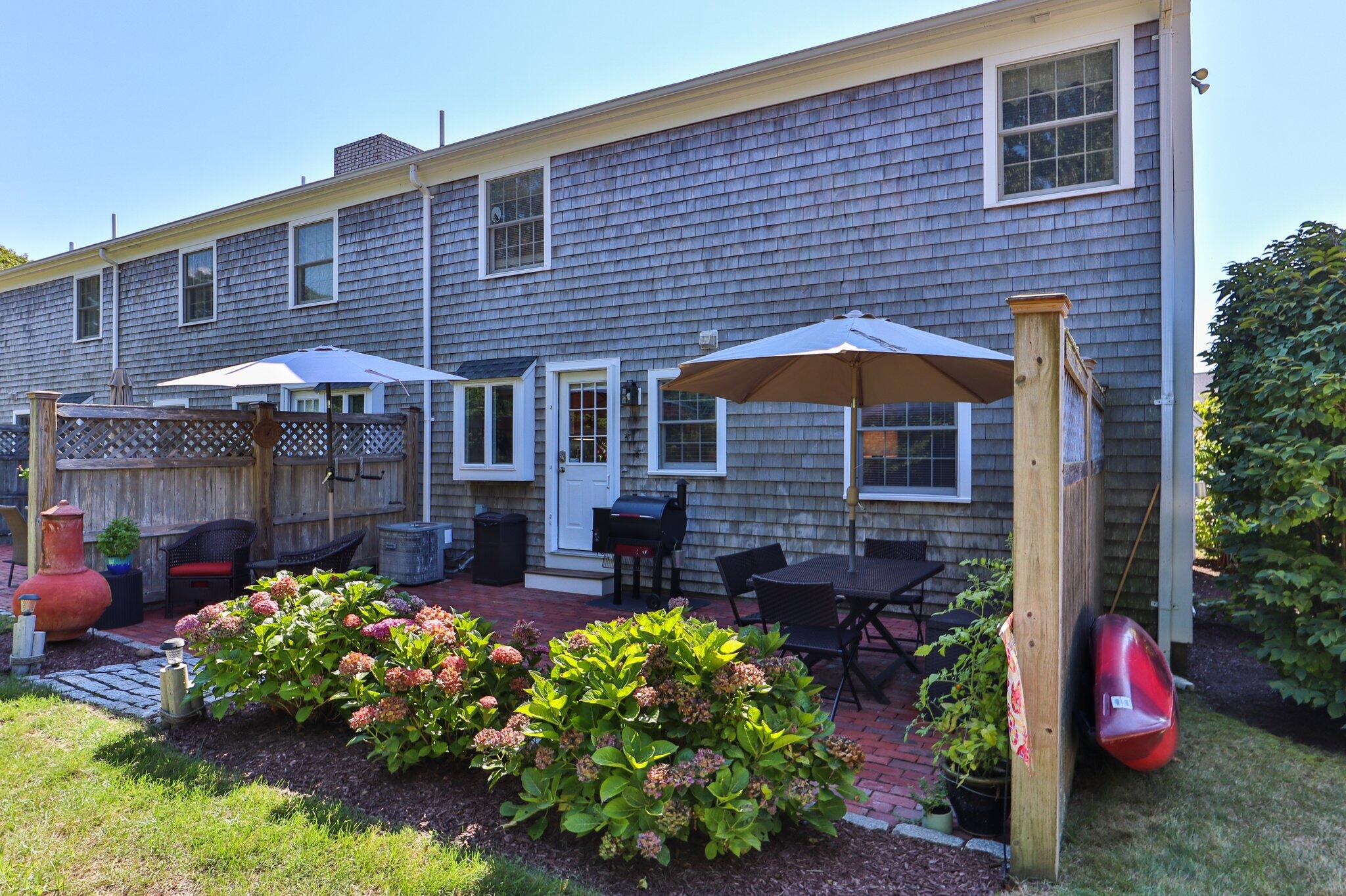 153 Jericho Path, Unit 8U Falmouth, MA 02540 - Photo 29 of 52 a view of a patio with chairs and plants