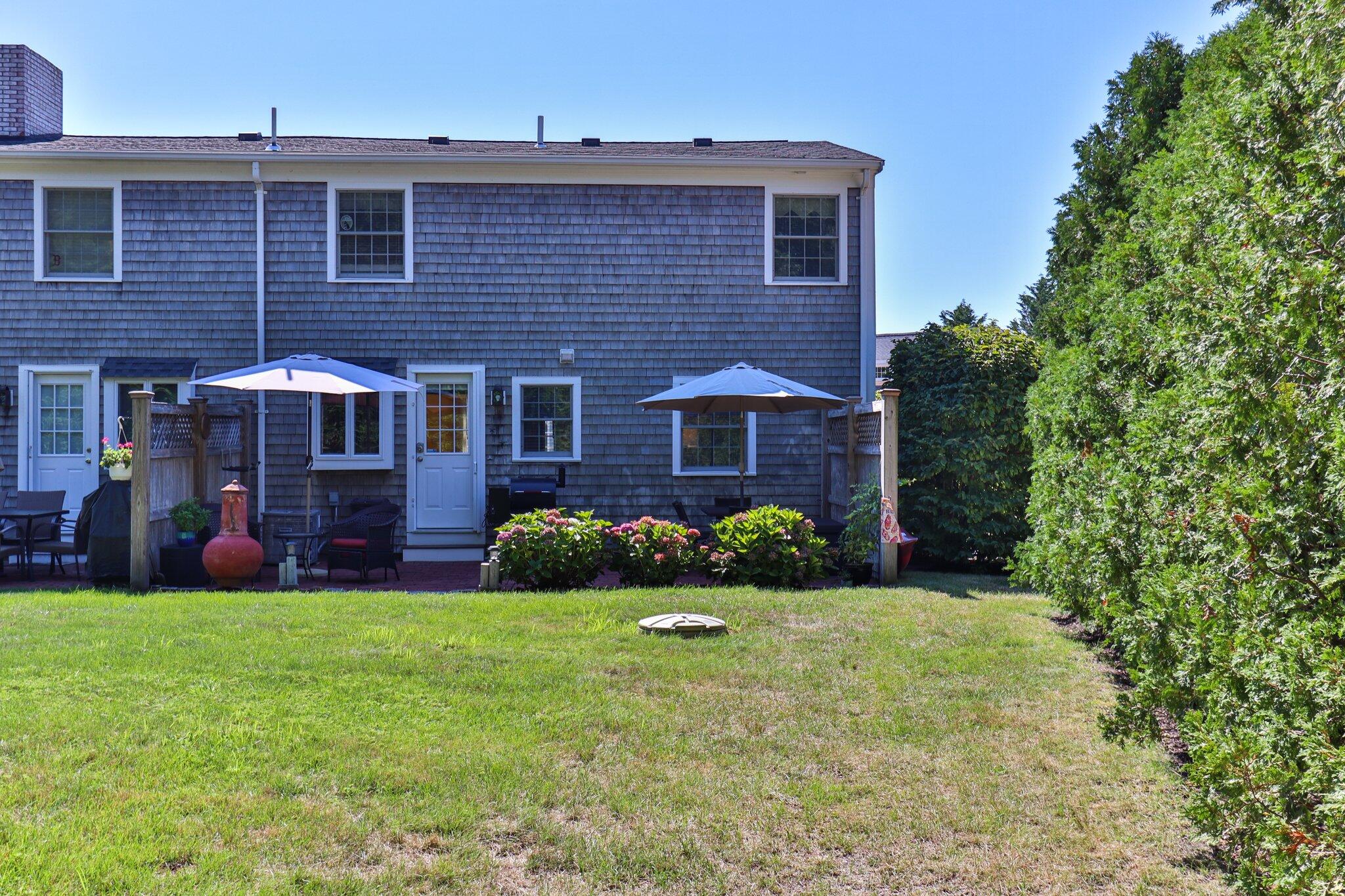 153 Jericho Path, Unit 8U Falmouth, MA 02540 - Photo 30 of 52 a front view of a house with garden