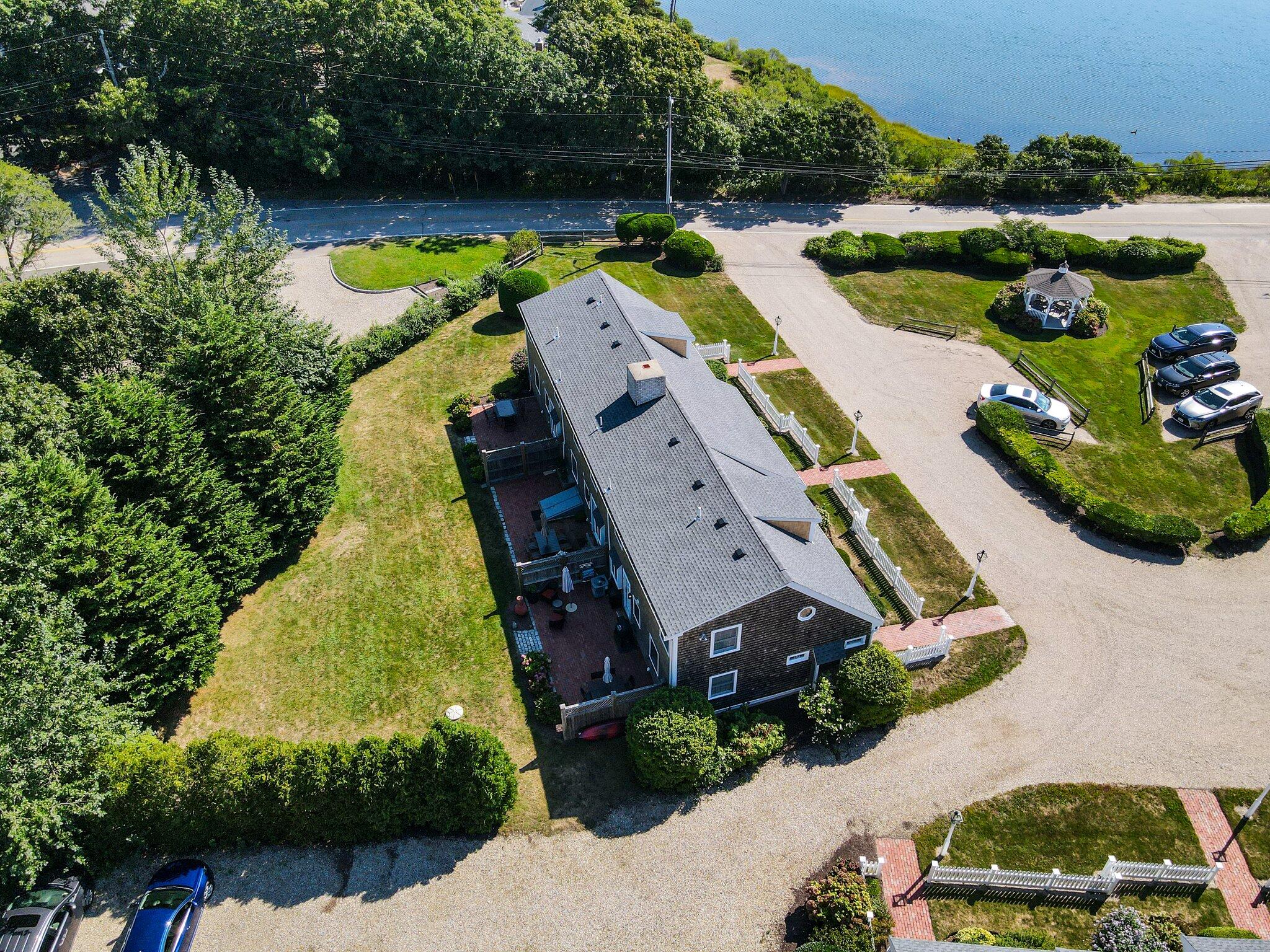 153 Jericho Path, Unit 8U Falmouth, MA 02540 - Photo 36 of 52 an aerial view of a house with a garden and lake view