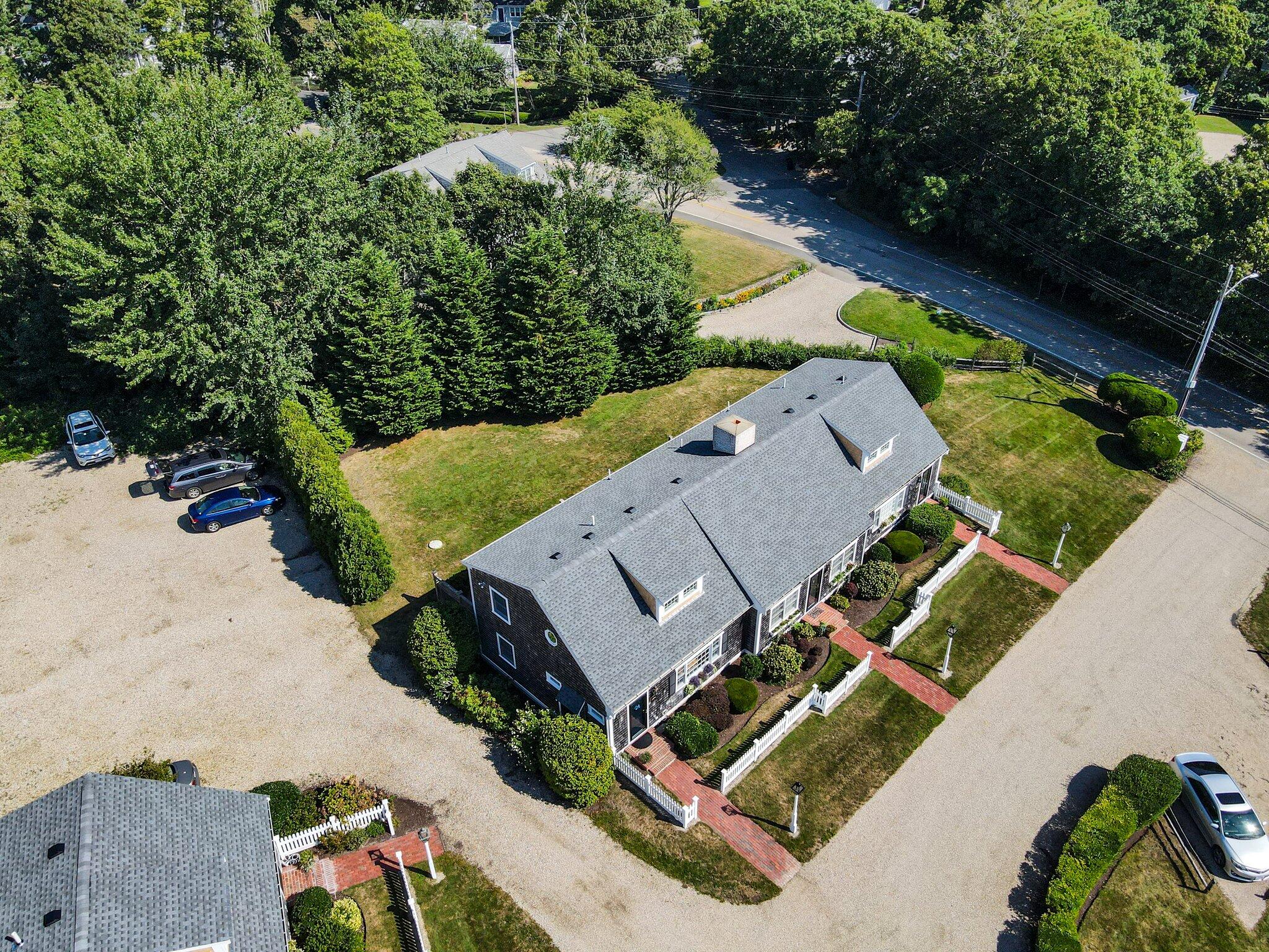 153 Jericho Path, Unit 8U Falmouth, MA 02540 - Photo 37 of 52 an aerial view of a house with a garden and swimming pool