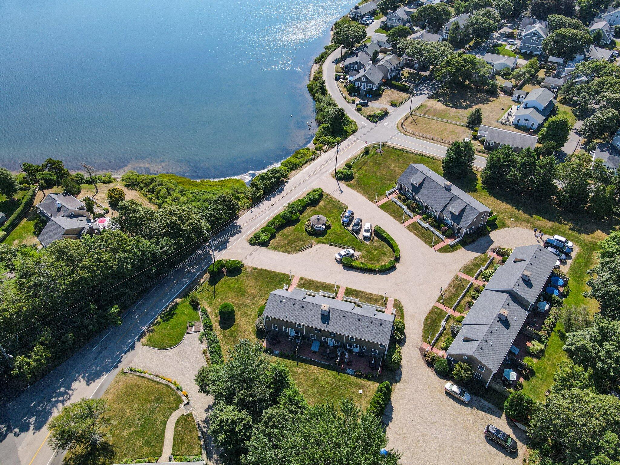 153 Jericho Path, Unit 8U Falmouth, MA 02540 - Photo 38 of 52 an aerial view of a house with a garden and swimming pool