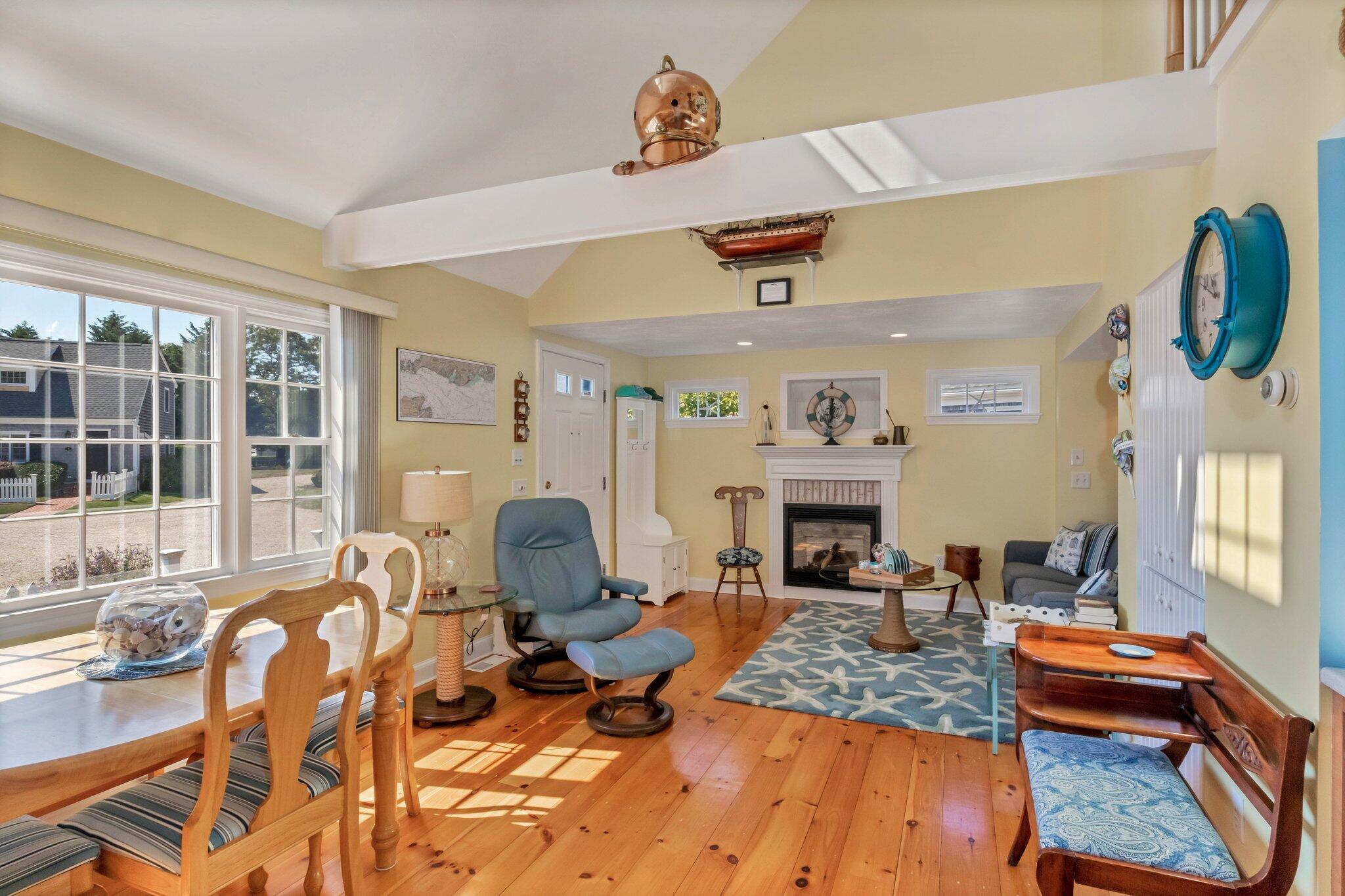 153 Jericho Path, Unit 8U Falmouth, MA 02540 - Photo 10 of 52 a living room with patio furniture and a fireplace