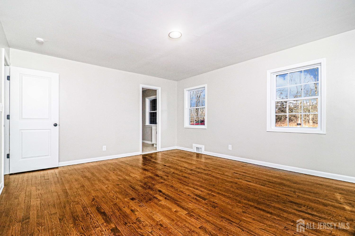 3 Brady Drive Gladstone, NJ 07934 - Photo 22 of 34 a view of an empty room with wooden floor and a window