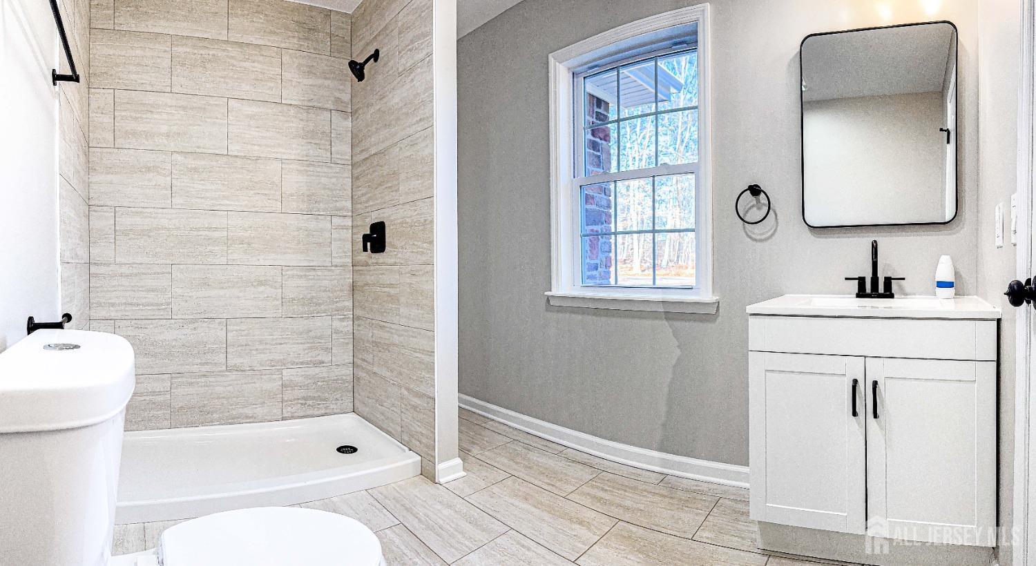 3 Brady Drive Gladstone, NJ 07934 - Photo 23 of 34 a bathroom with a sink a toilet and shower