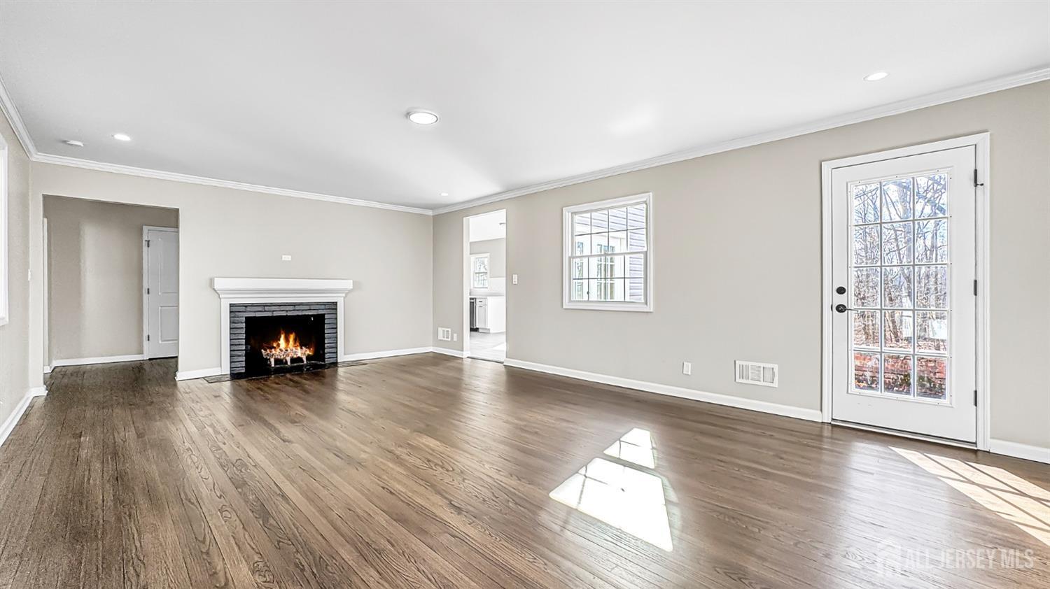 3 Brady Drive Gladstone, NJ 07934 - Photo 6 of 34 a view of an empty room with wooden floor fireplace and a window