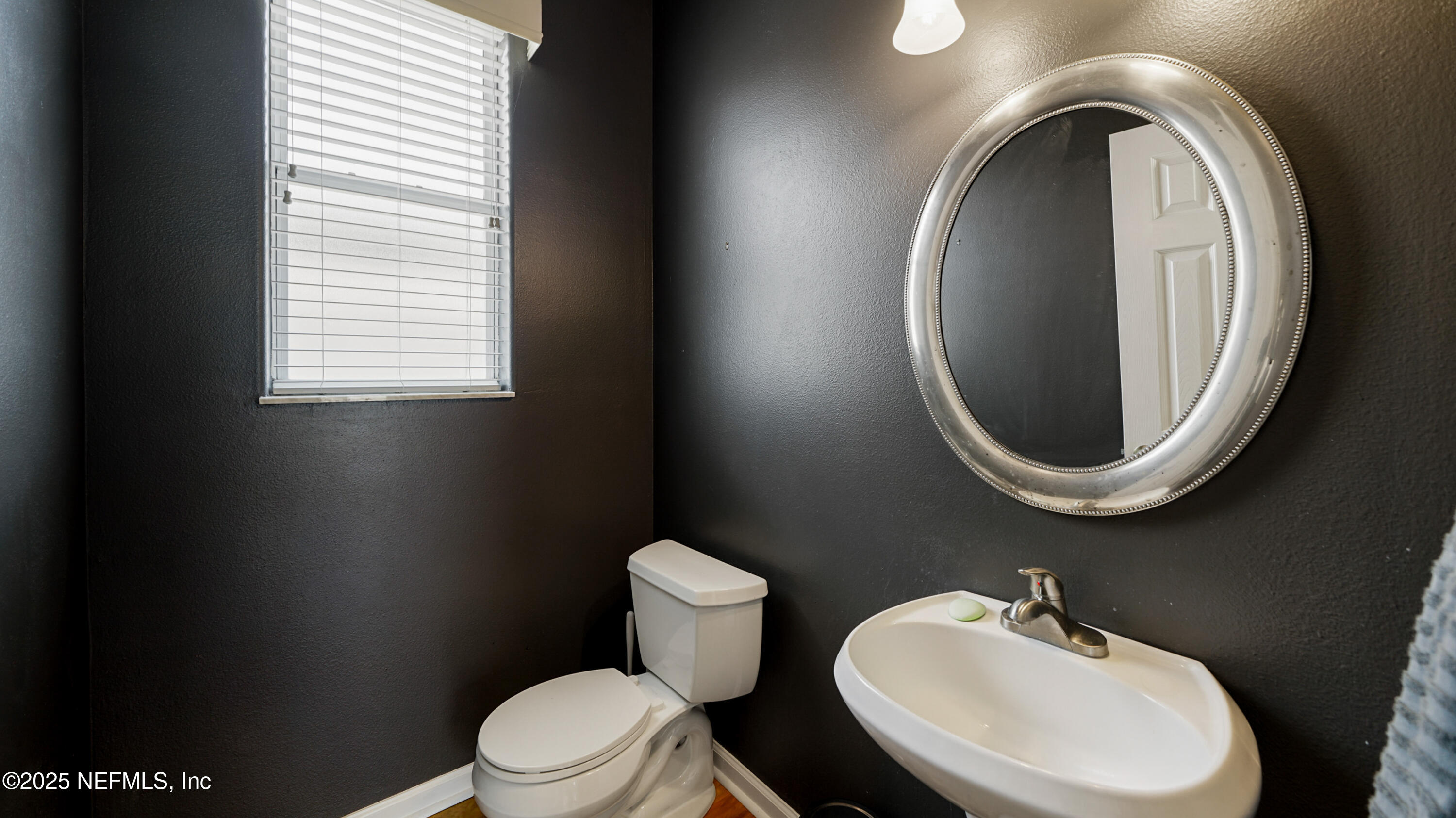 165 Cedar Ridge Circle St. Augustine, FL 32080 - Photo 15 of 46 a bathroom with a toilet a sink and a mirror