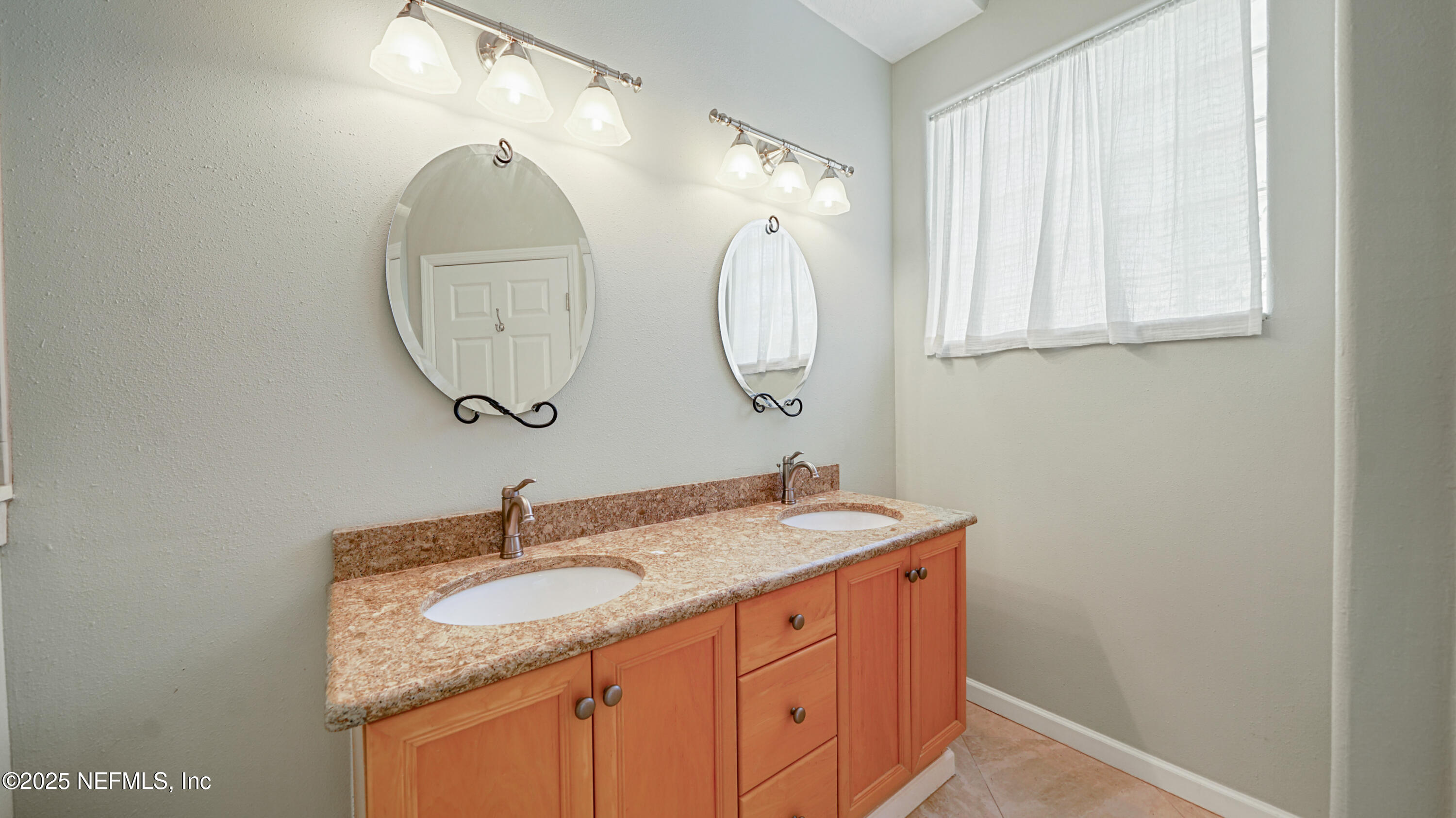 165 Cedar Ridge Circle St. Augustine, FL 32080 - Photo 19 of 46 a bathroom with a granite countertop sink and a mirror