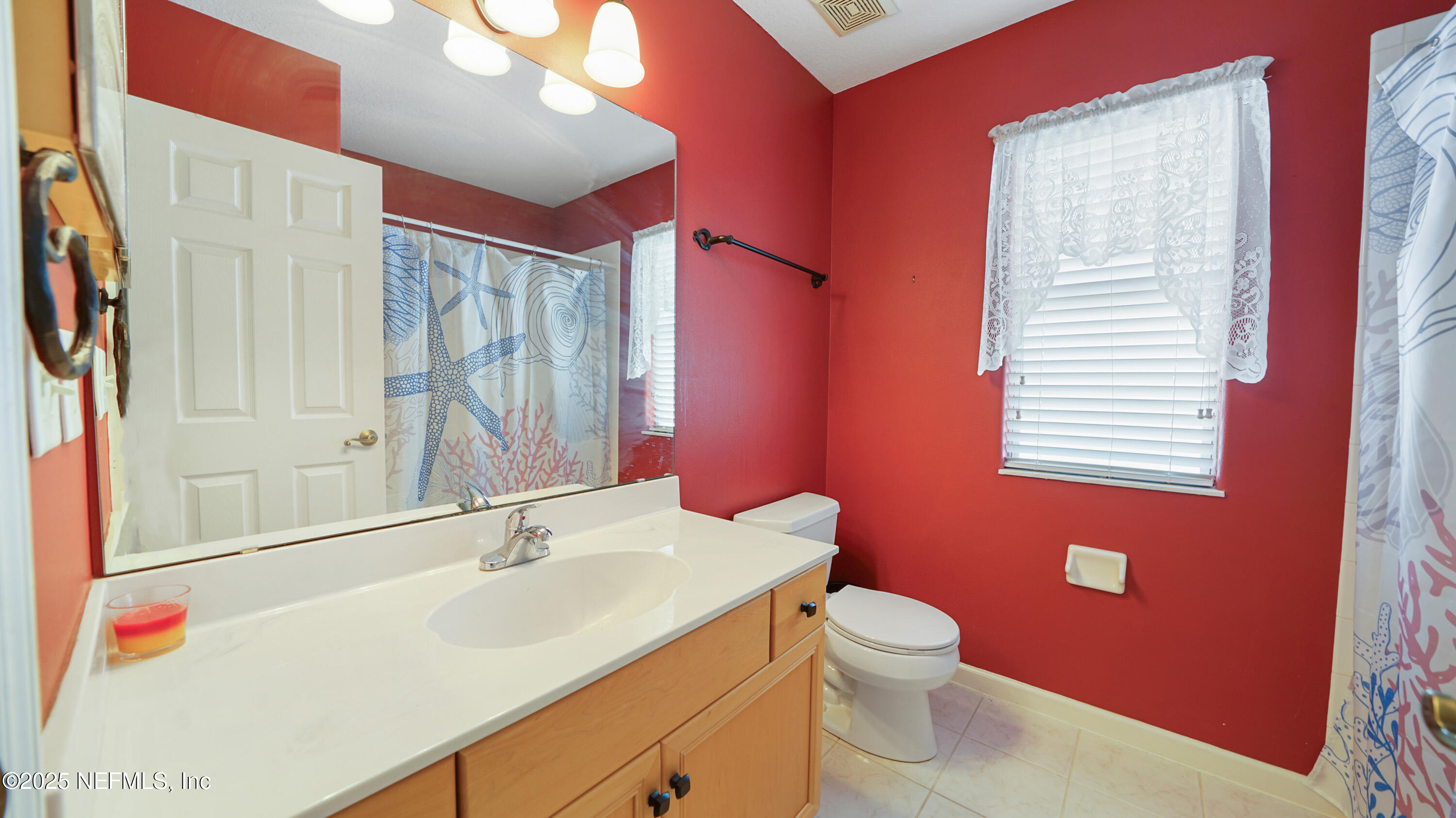 165 Cedar Ridge Circle St. Augustine, FL 32080 - Photo 29 of 46 a bathroom with a sink a toilet and a mirror