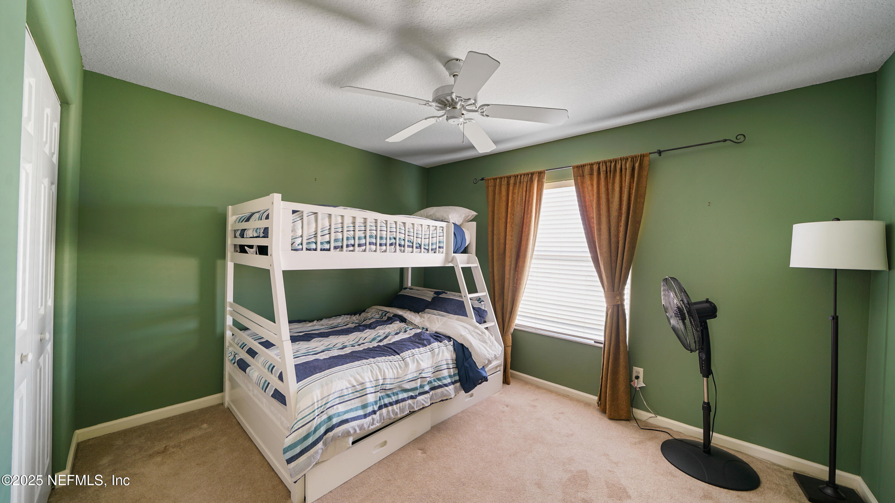 165 Cedar Ridge Circle St. Augustine, FL 32080 - Photo 30 of 46 a bedroom with a bed and a chandelier