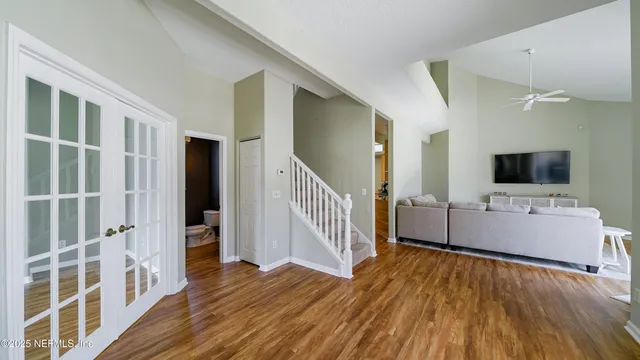 a view of a living room with furniture and flat screen tv
