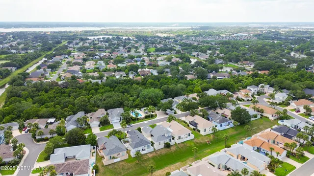 an aerial view of residential houses with outdoor space