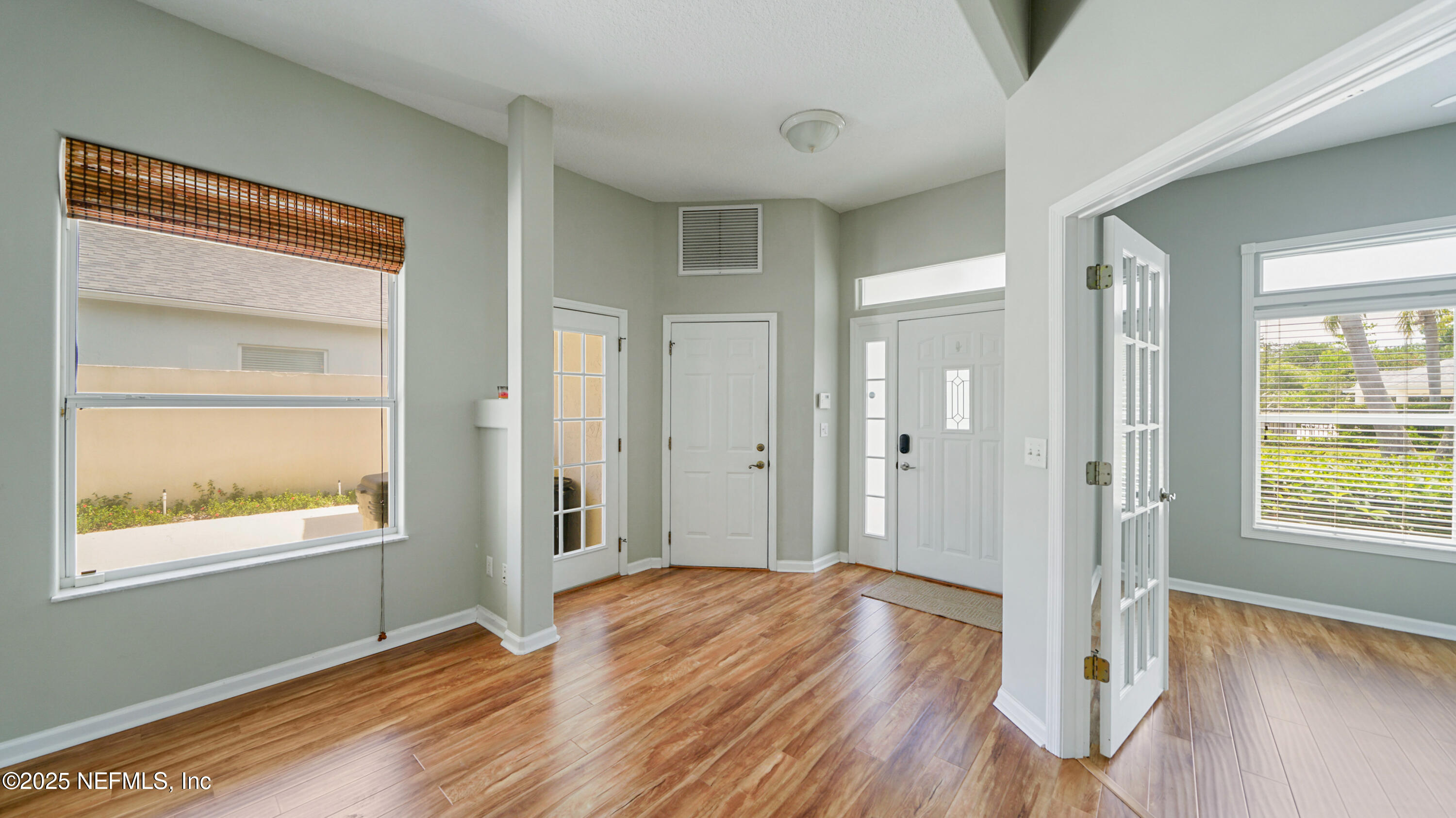 165 Cedar Ridge Circle St. Augustine, FL 32080 - Photo 4 of 46 a view of an empty room with wooden floor and a window