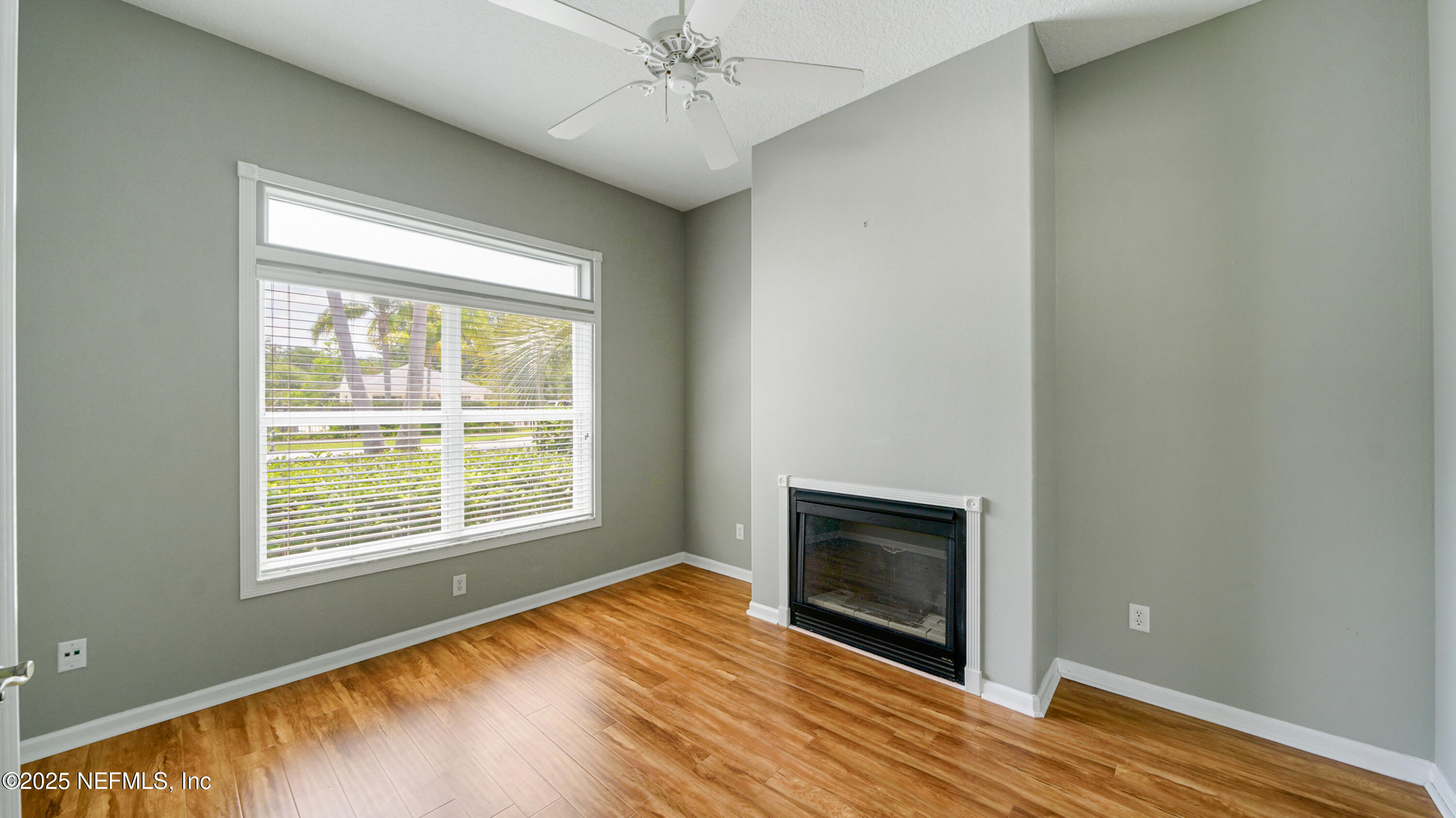165 Cedar Ridge Circle St. Augustine, FL 32080 - Photo 5 of 46 a view of an empty room with wooden floor and a window