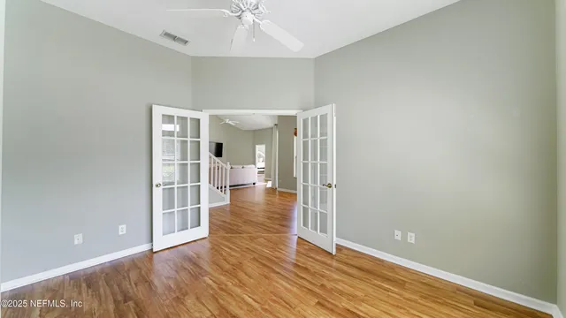 wooden floor in an empty room with a window