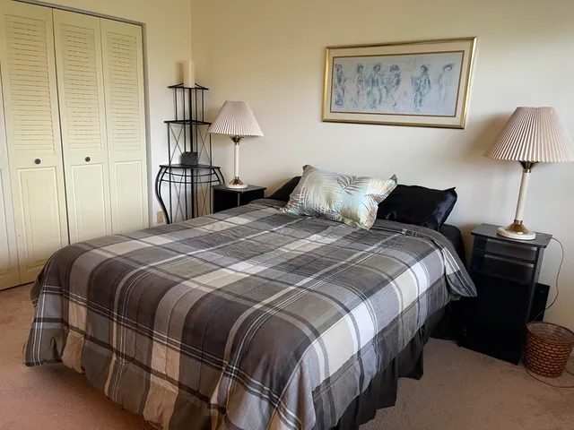 a bedroom with a bed and a lamp