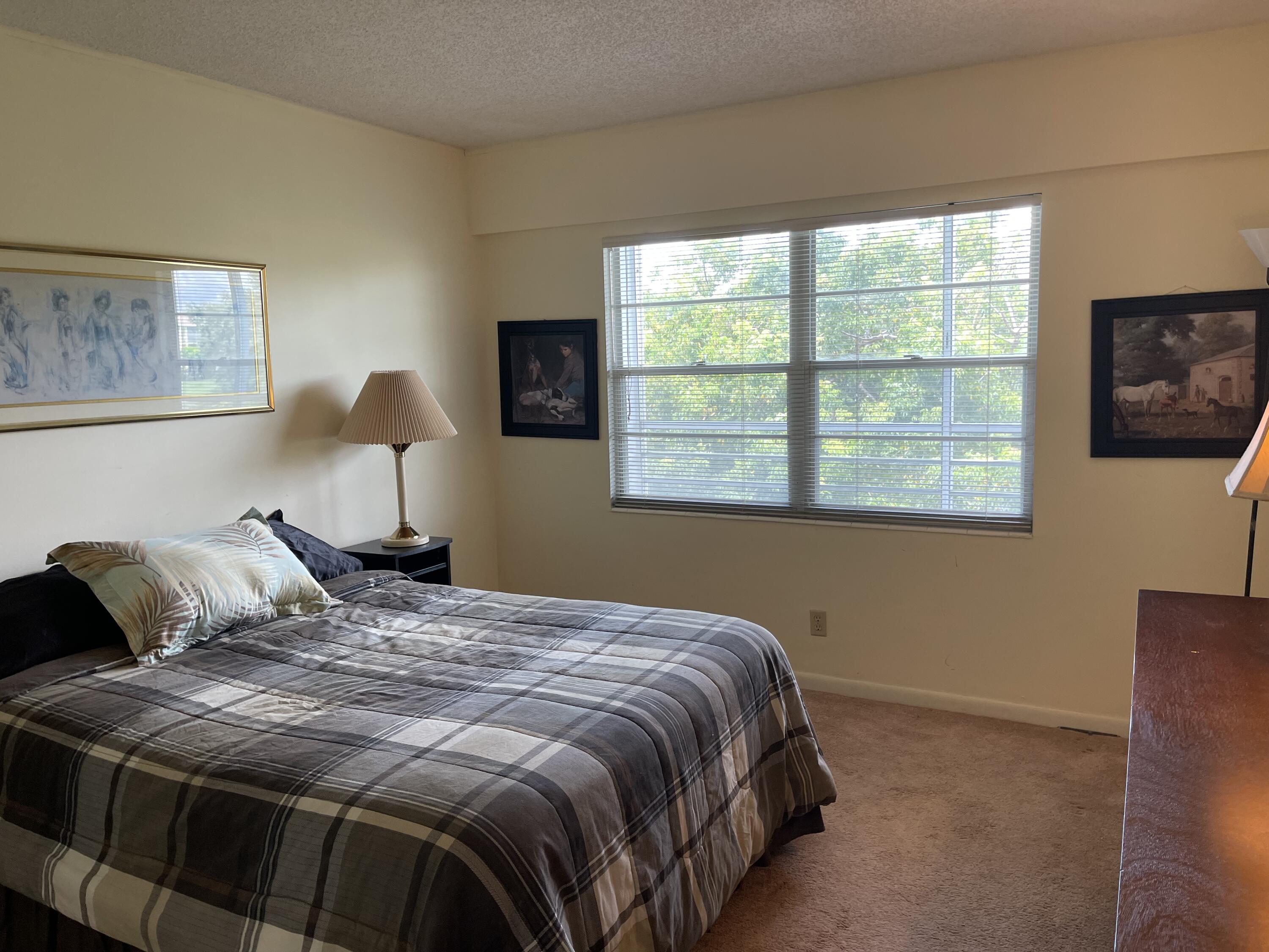 198 Dorset East, Unit E Boca Raton, FL 33434 - Photo 18 of 23 a bedroom with a bed and a window