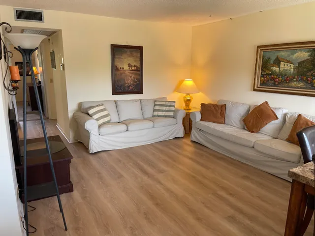 a living room with furniture and a lamp