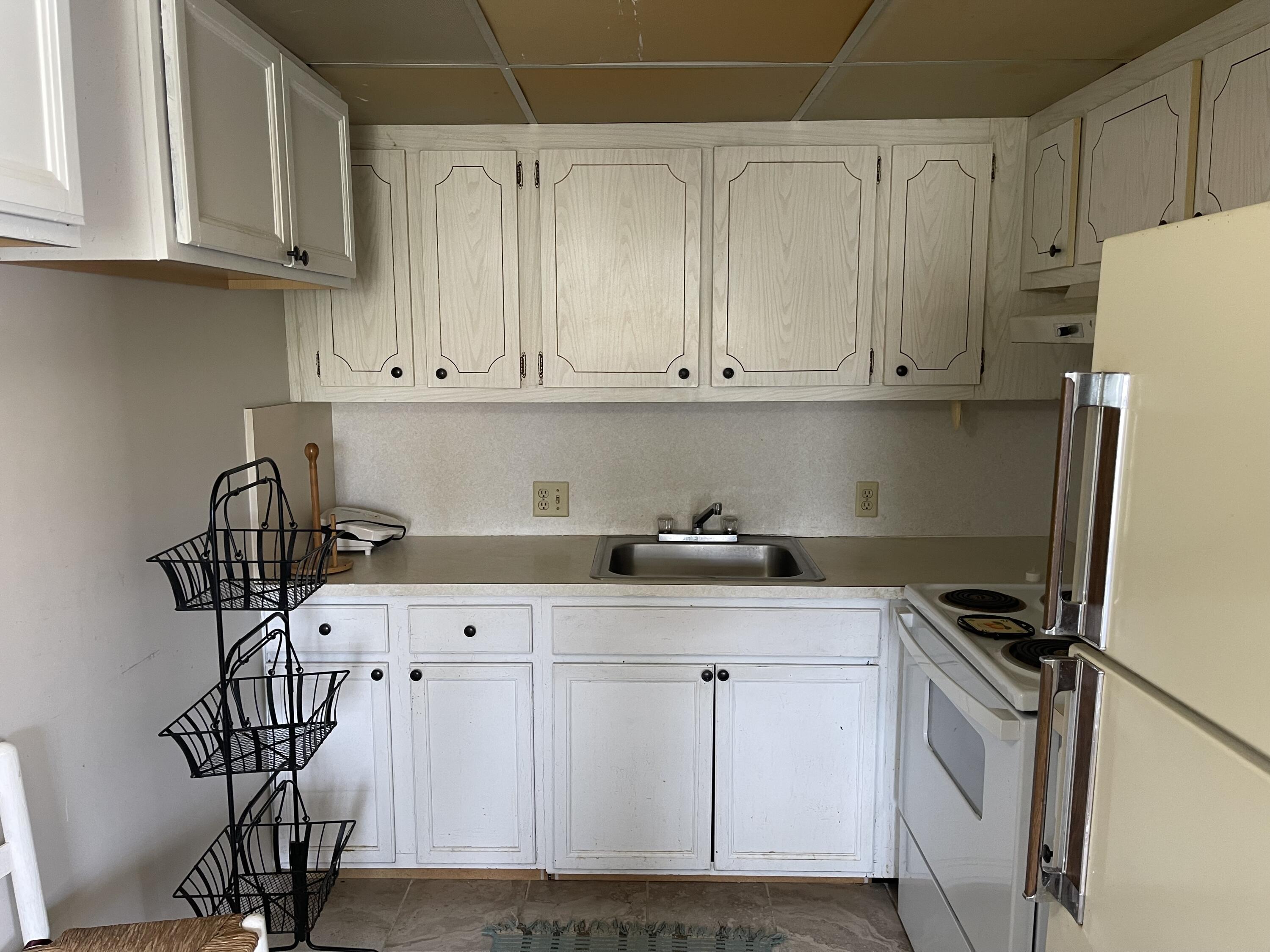 198 Dorset East, Unit E Boca Raton, FL 33434 - Photo 8 of 23 a kitchen with stainless steel appliances a cabinets and a counter top space