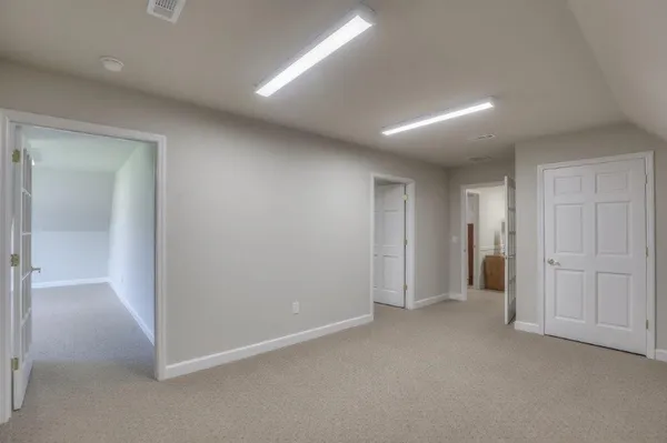 an empty room with closet and bathroom