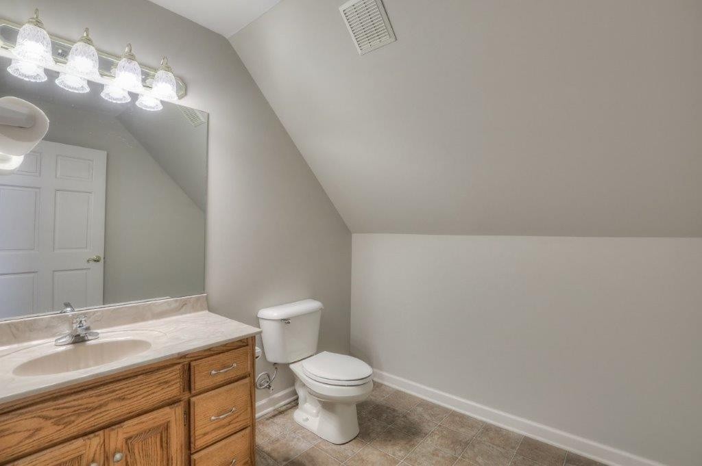 1404 North Main Street Shelbyville, TN 37160 - Photo 25 of 27 a bathroom with a toilet a sink and mirror
