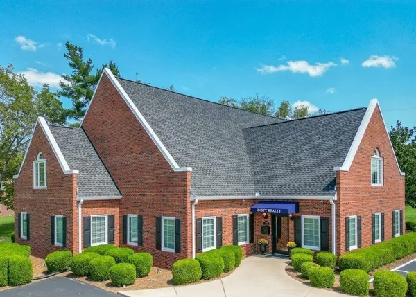 a front view of residential houses with yard and green space