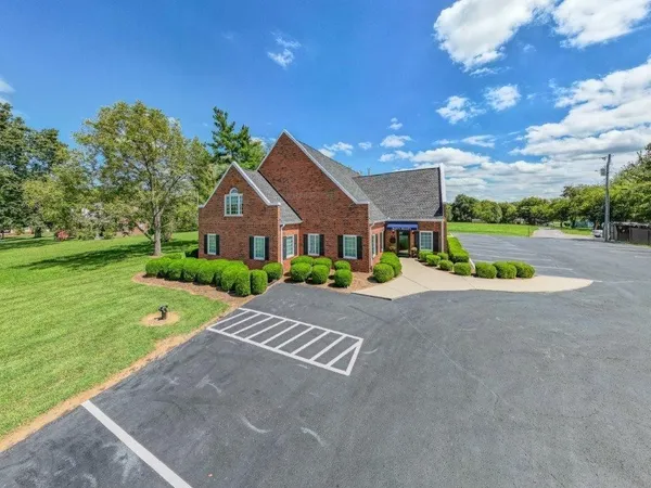 a front view of house with yard and green space