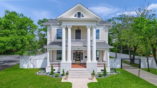 a front view of a house with a yard and trees