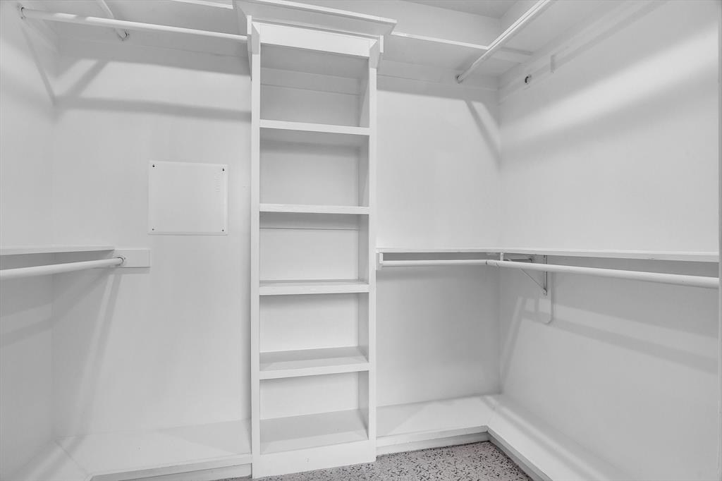 511 South Travis Street Sherman, TX 75090 - Photo 16 of 40 a view of walk in closet with empty racks