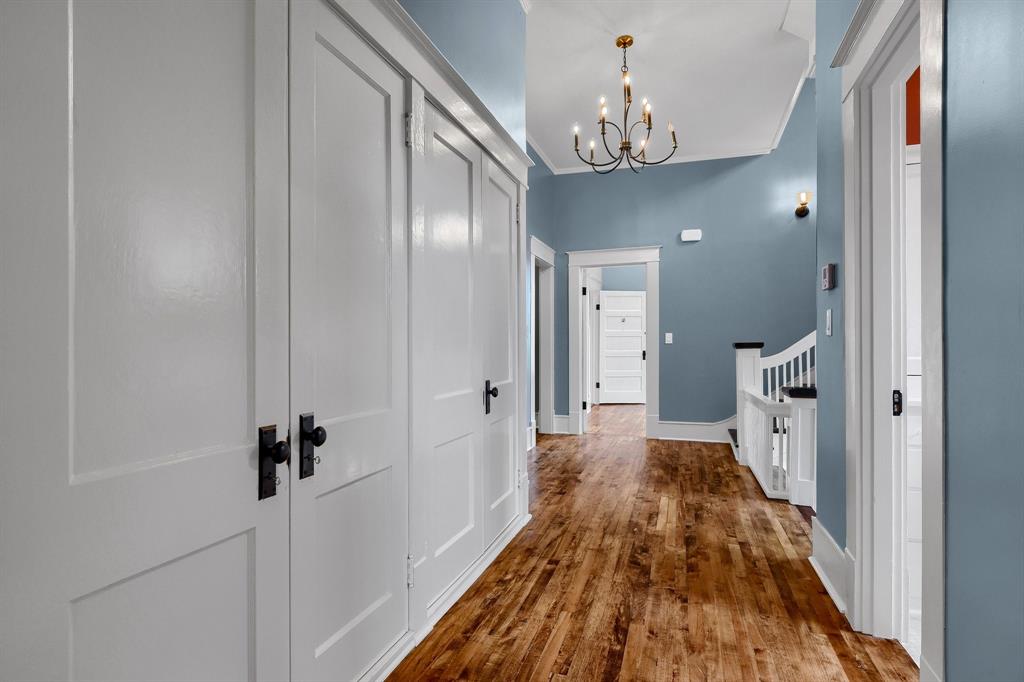 511 South Travis Street Sherman, TX 75090 - Photo 21 of 40 a view of a hallway with wooden floor and staircase