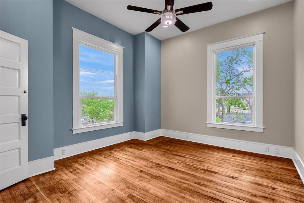 511 South Travis Street Sherman, TX 75090 - Photo 22 of 40 a view of empty room with wooden floor and fan