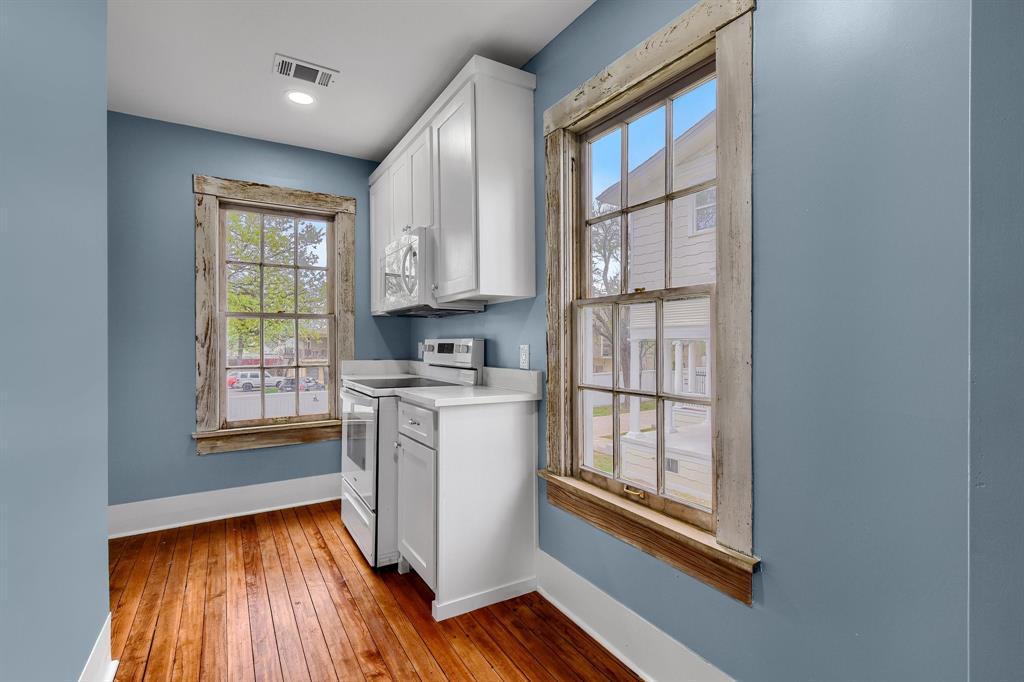 511 South Travis Street Sherman, TX 75090 - Photo 31 of 40 a kitchen with wooden cabinets and a window