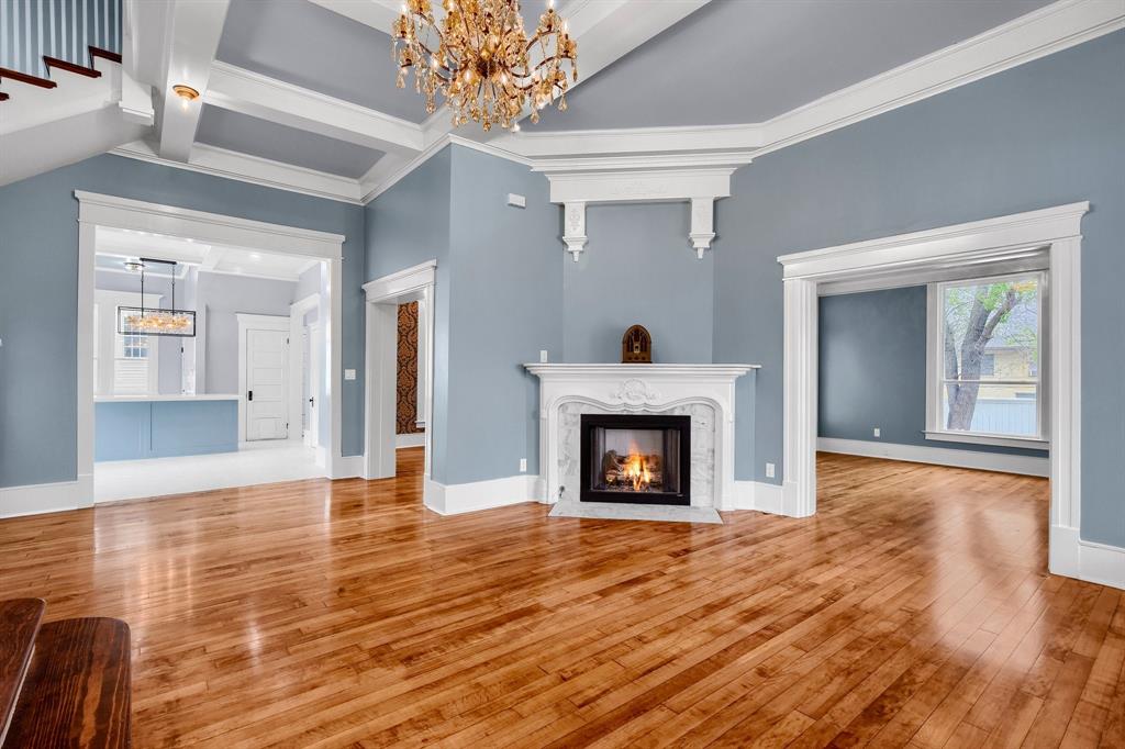 511 South Travis Street Sherman, TX 75090 - Photo 38 of 40 a view of an empty room with wooden floor and a fireplace