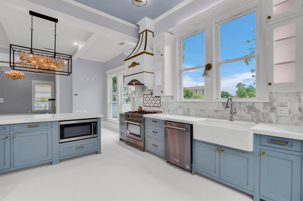 511 South Travis Street Sherman, TX 75090 - Photo 8 of 40 a kitchen with a sink stove and microwave