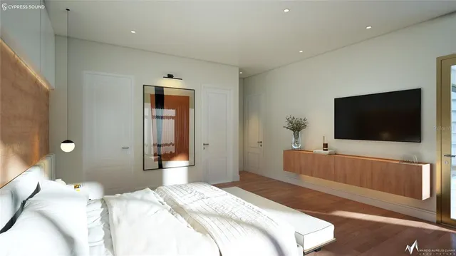a bedroom with a flat screen tv and a bed