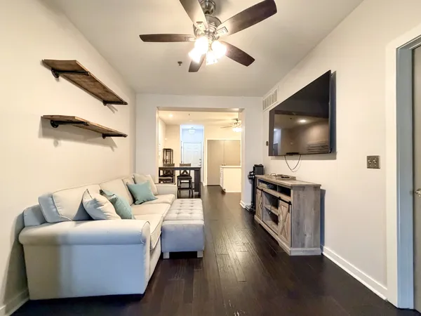 a living room with furniture and a flat screen tv