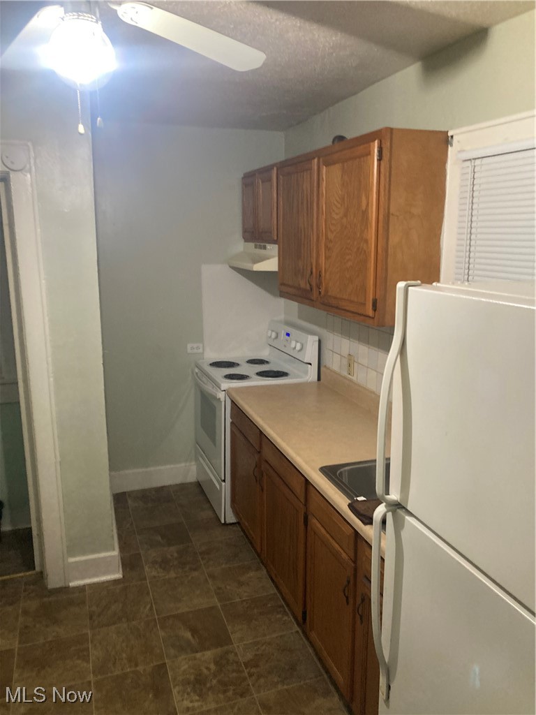 851 Springdale Street Akron, OH 44310 - Photo 9 of 22 Kitchen with range hood, white electric stove, ceiling fan, and fridge