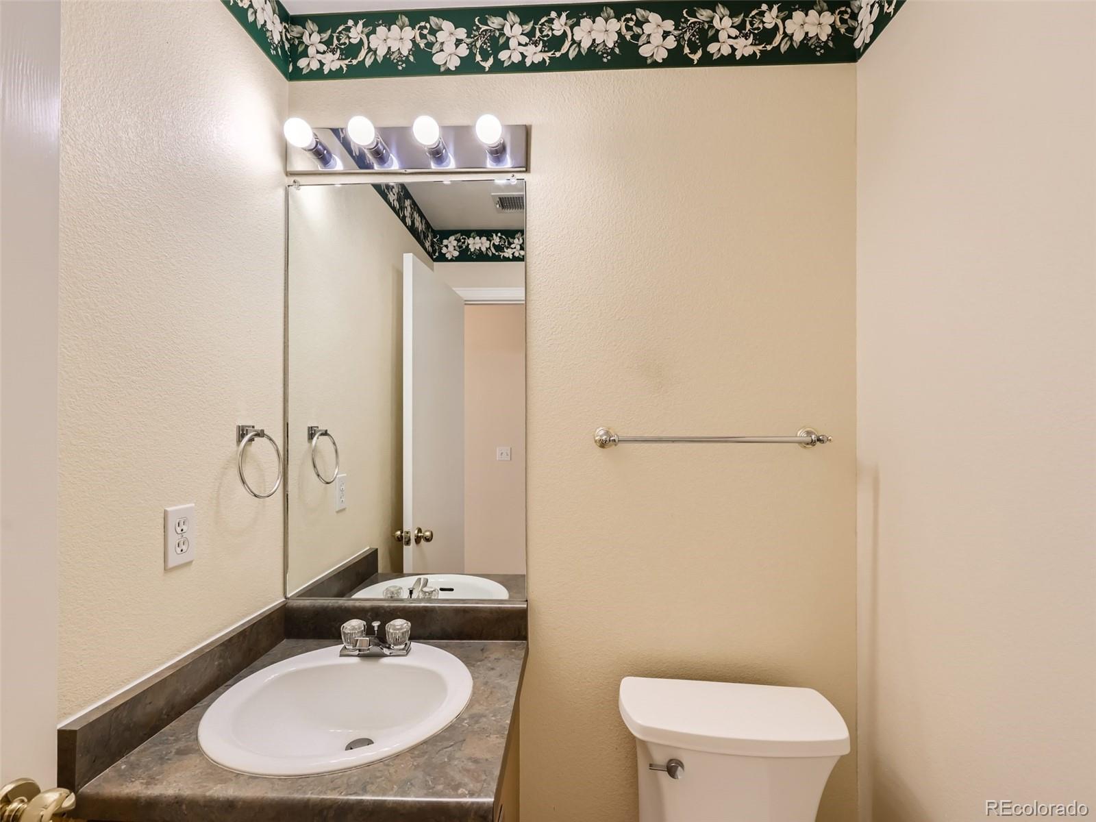 422 Chambers Way Aurora, CO 80011 - Photo 20 of 44 a bathroom with a toilet sink and mirror