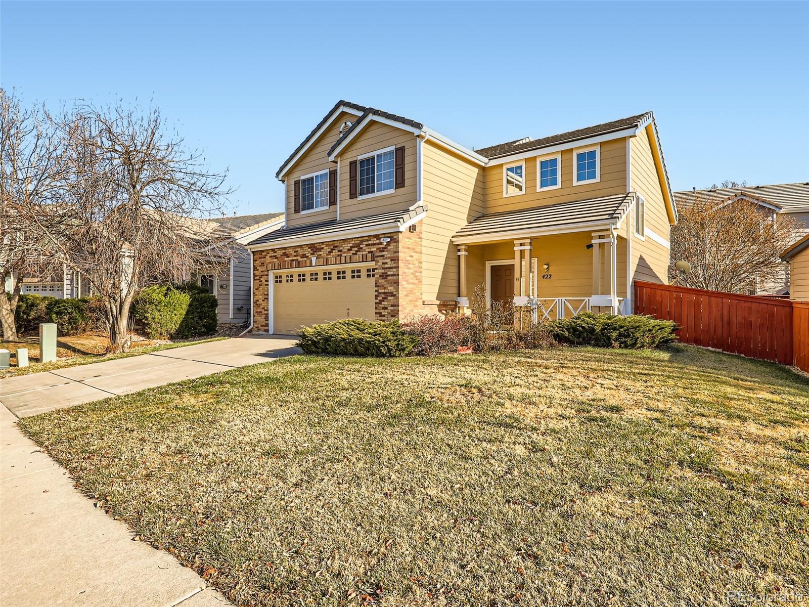 422 Chambers Way Aurora, CO 80011 - Photo 2 of 44 a front view of a house with a yard