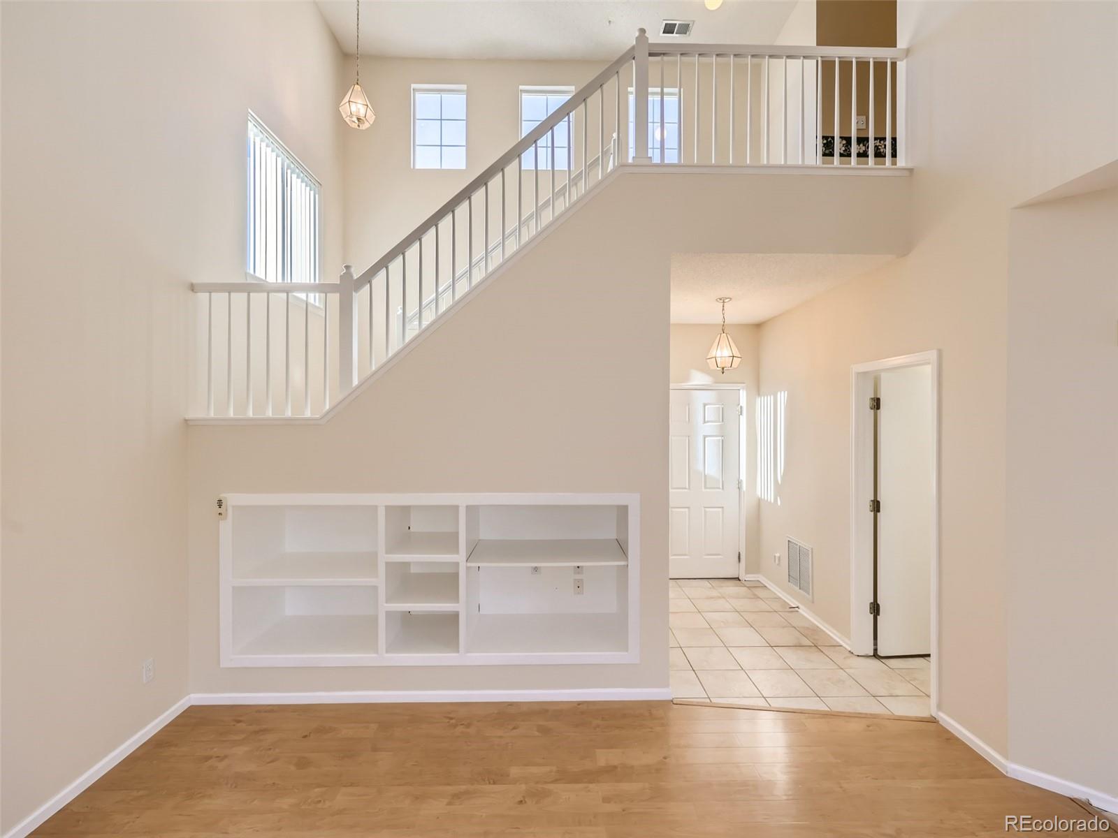 422 Chambers Way Aurora, CO 80011 - Photo 21 of 44 a view of staircase with white walls and windows