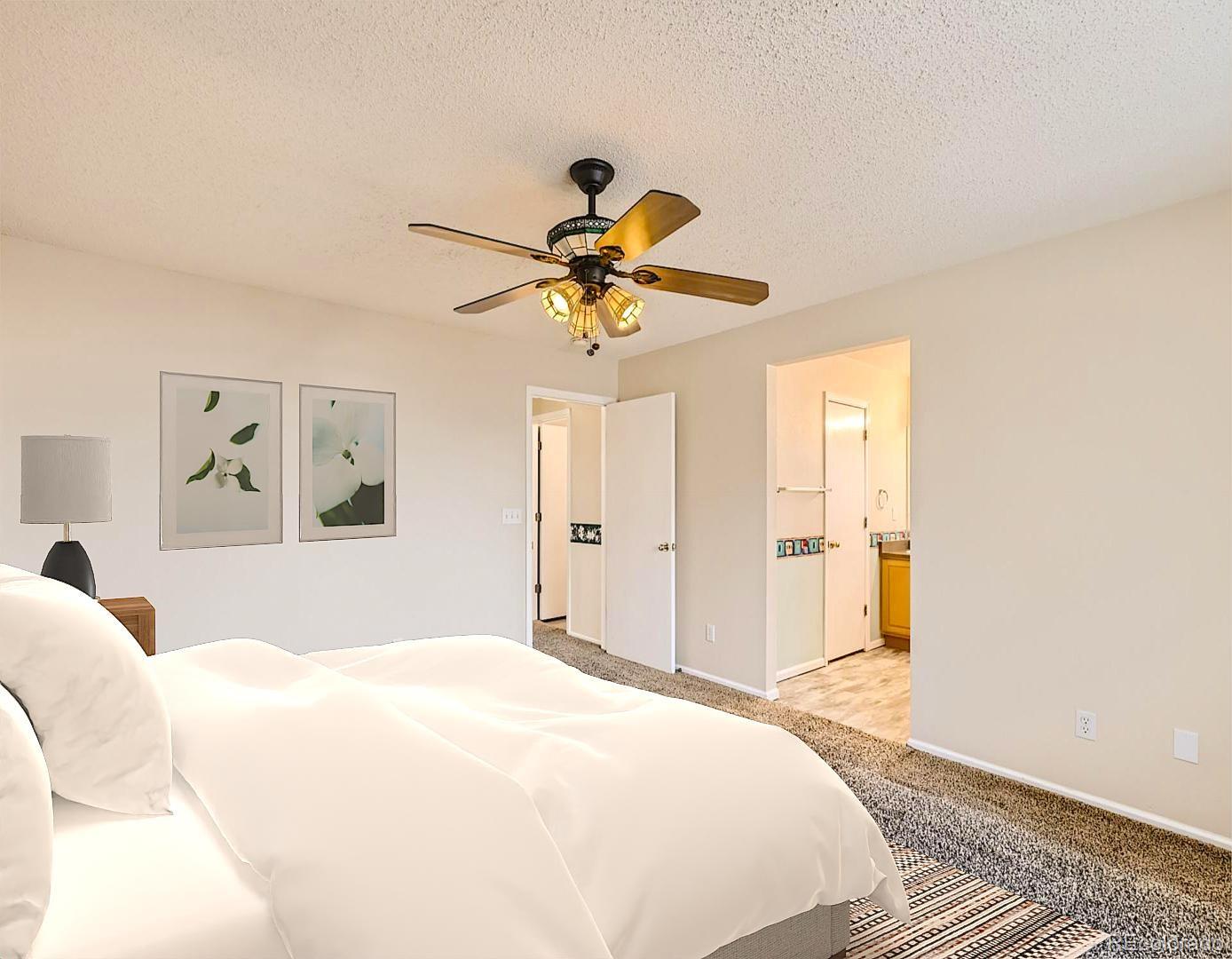 422 Chambers Way Aurora, CO 80011 - Photo 24 of 44 a bedroom with a bed and a chandelier