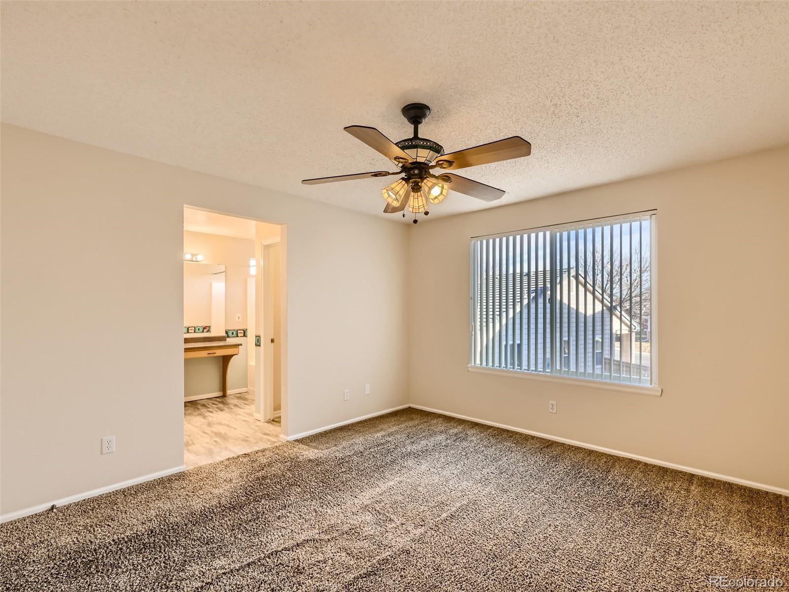 422 Chambers Way Aurora, CO 80011 - Photo 27 of 44 a view of an empty room with a window