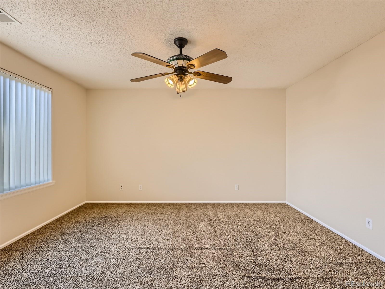 422 Chambers Way Aurora, CO 80011 - Photo 28 of 44 a view of a big room with wooden floor and a chandelier fan