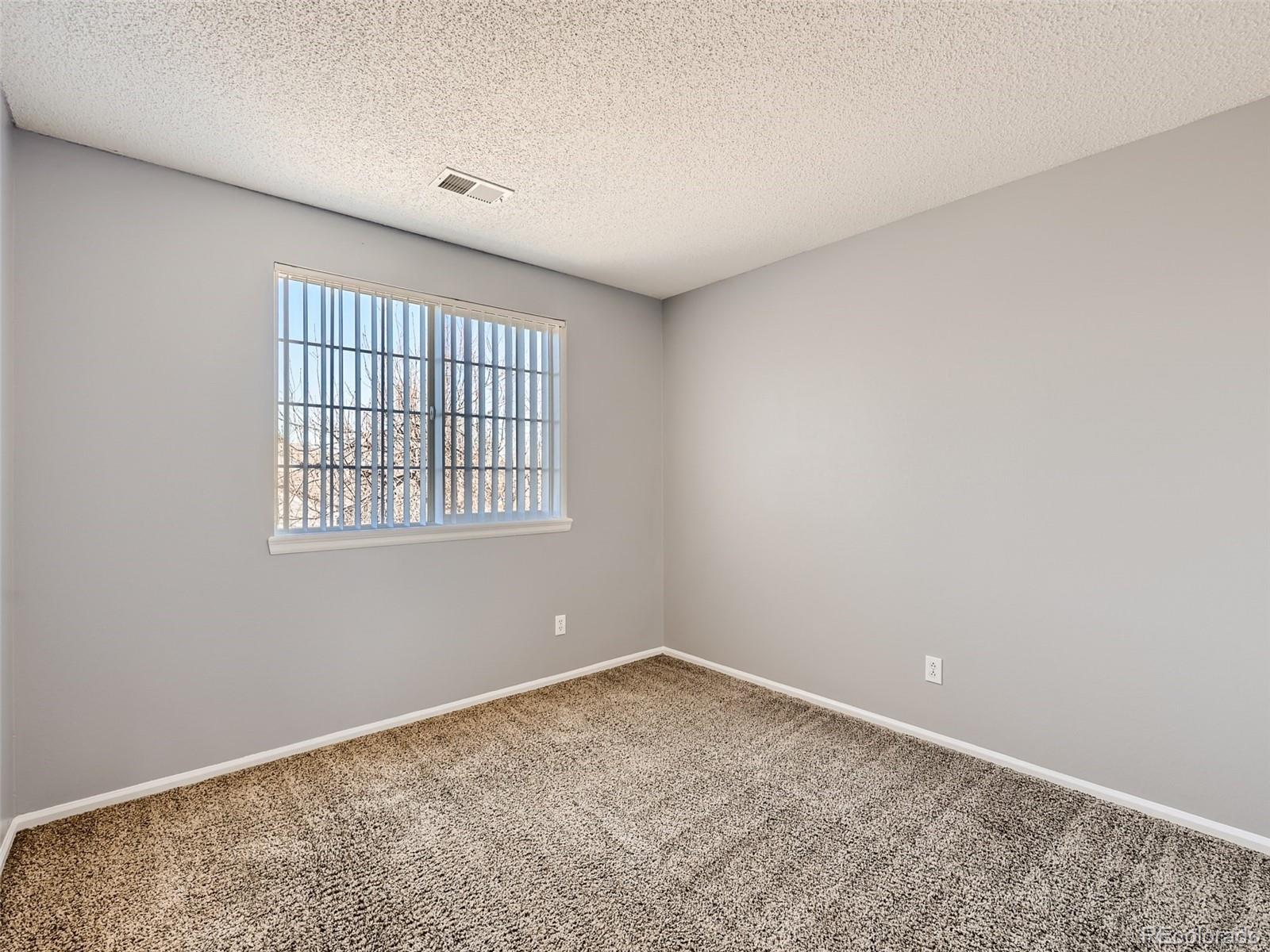 422 Chambers Way Aurora, CO 80011 - Photo 34 of 44 wooden floor in an empty room with a window