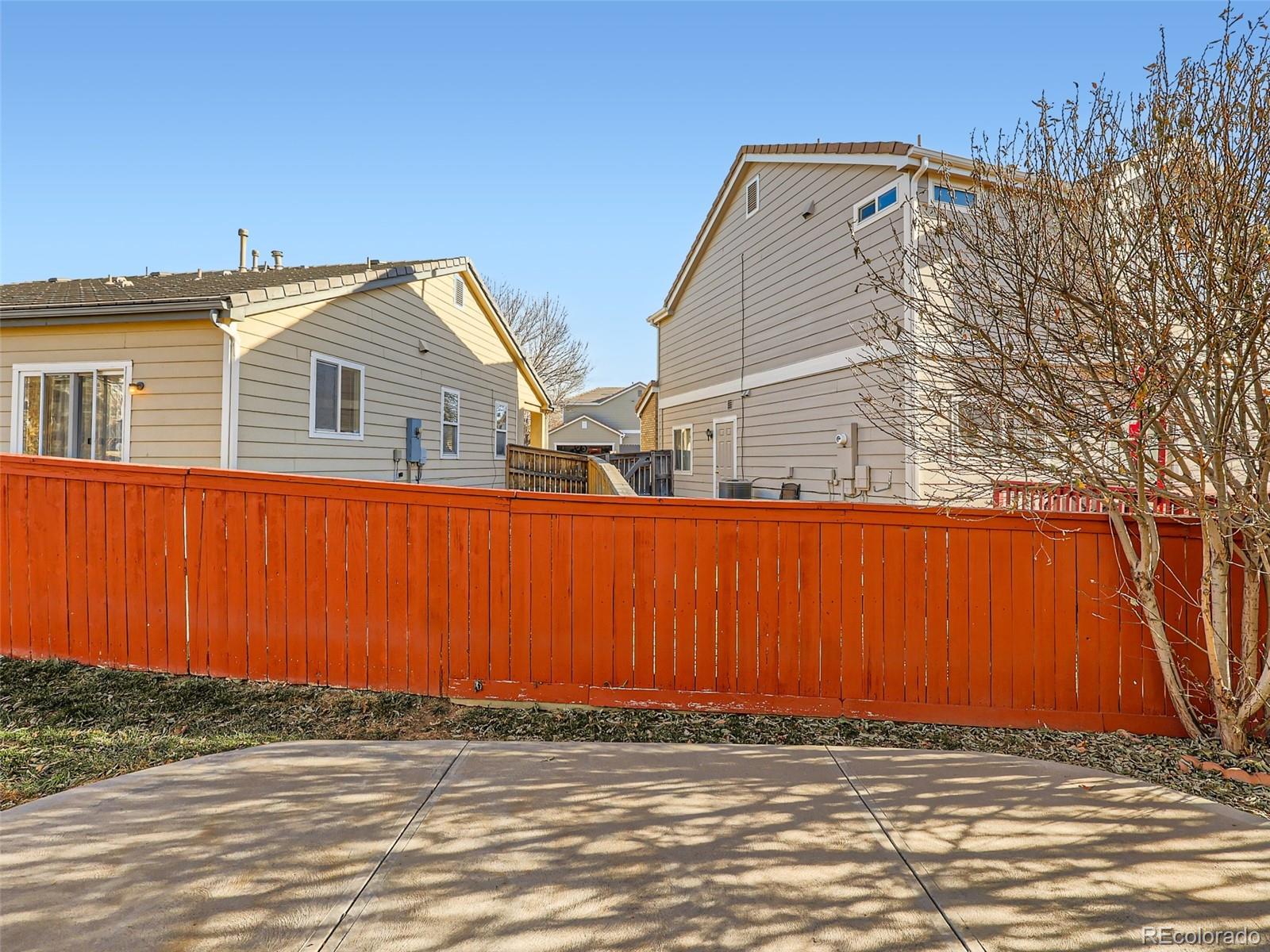 422 Chambers Way Aurora, CO 80011 - Photo 40 of 44 a view of a house with a wooden fence