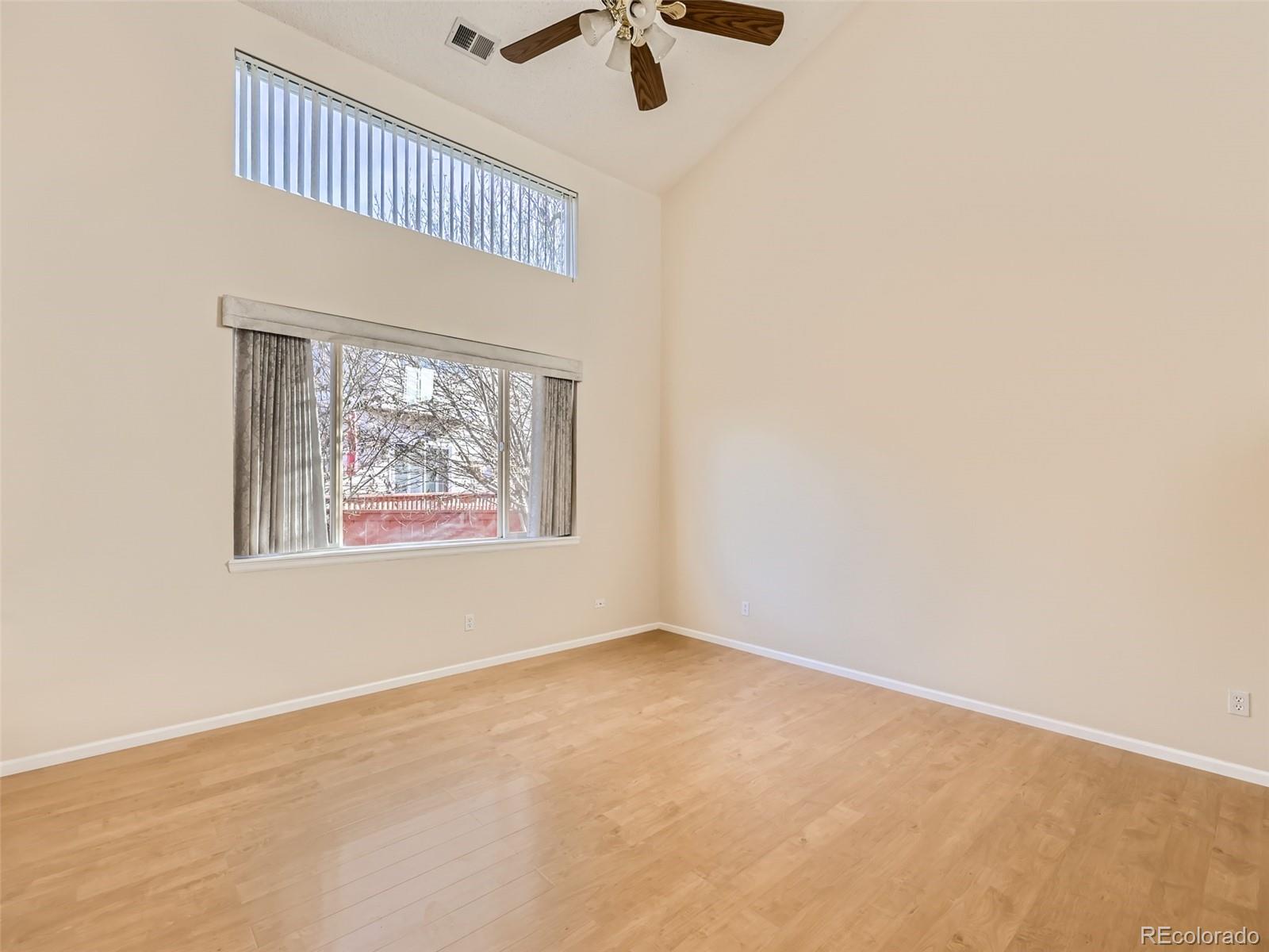 422 Chambers Way Aurora, CO 80011 - Photo 8 of 44 an empty room with a ceiling fan and window
